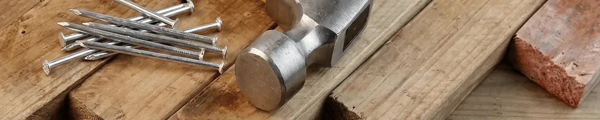 Hammer and nails on hardwood flooring boards in Little Rock, AR